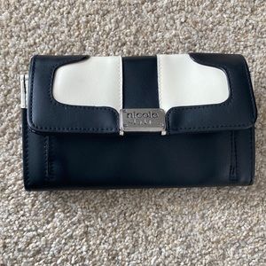 Black and white Nicole Miller wallet. Pink inside
